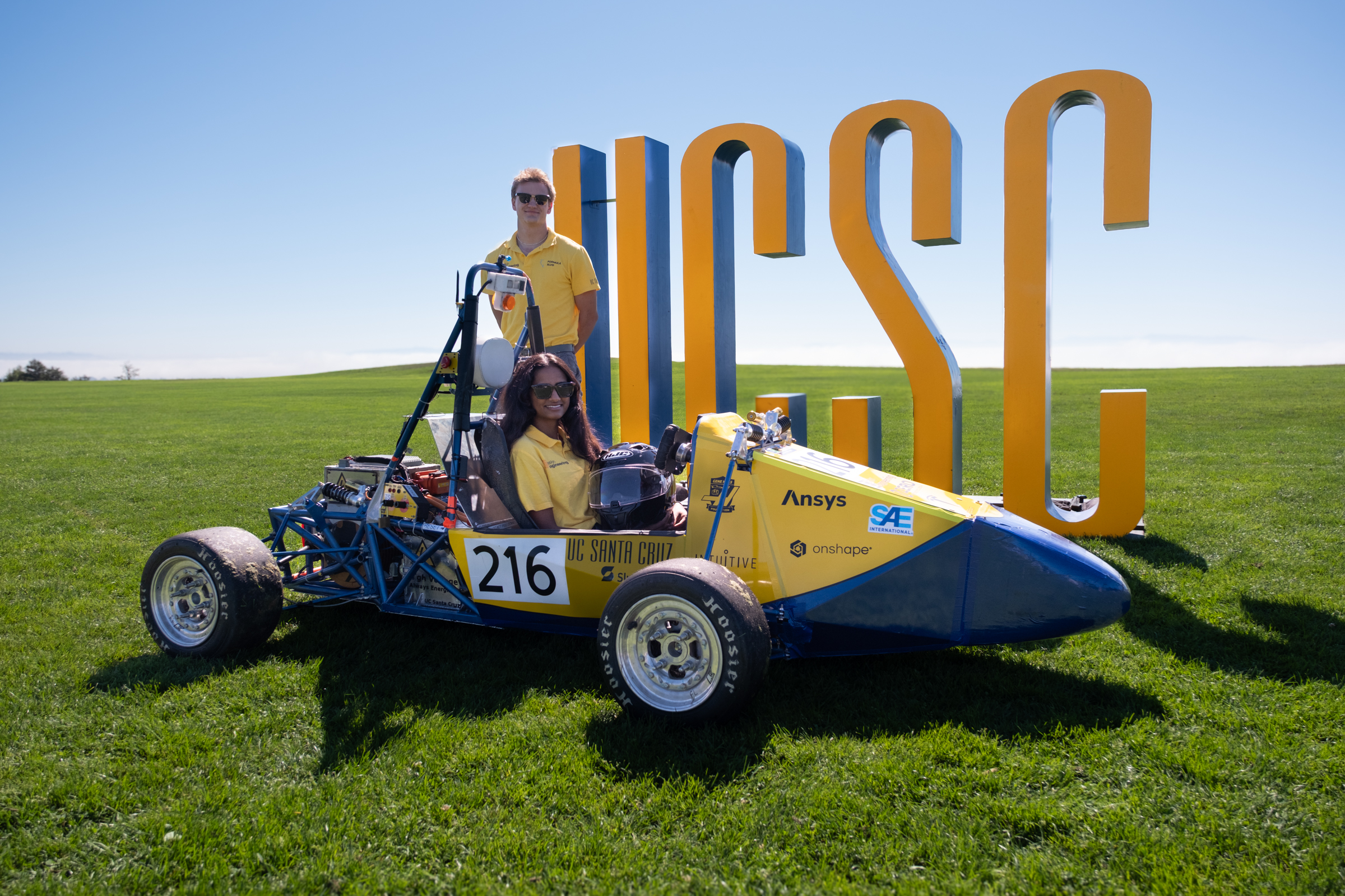 Formula Slug with their race car on the UCSC field
