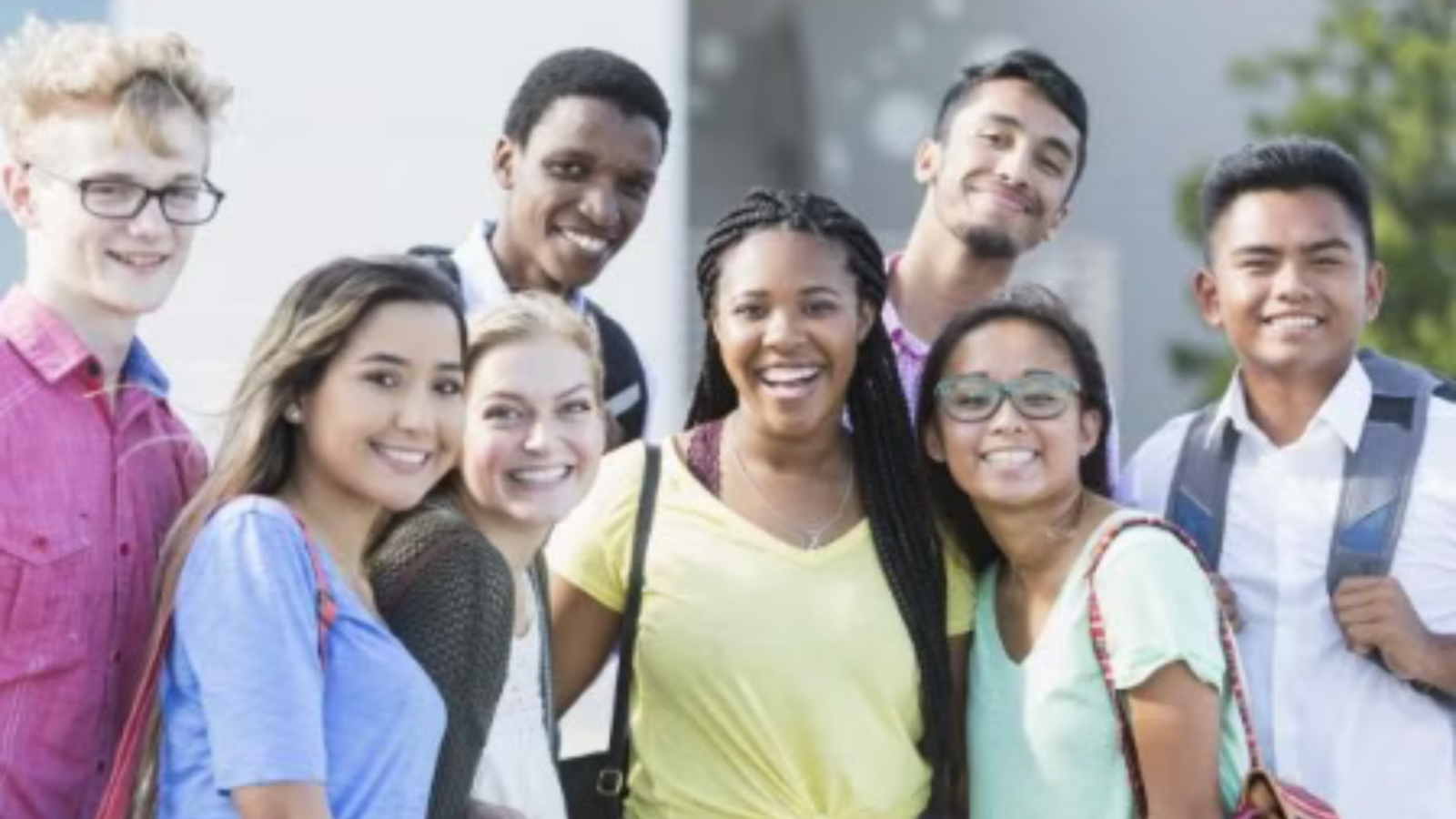 Group smiling as they pose.