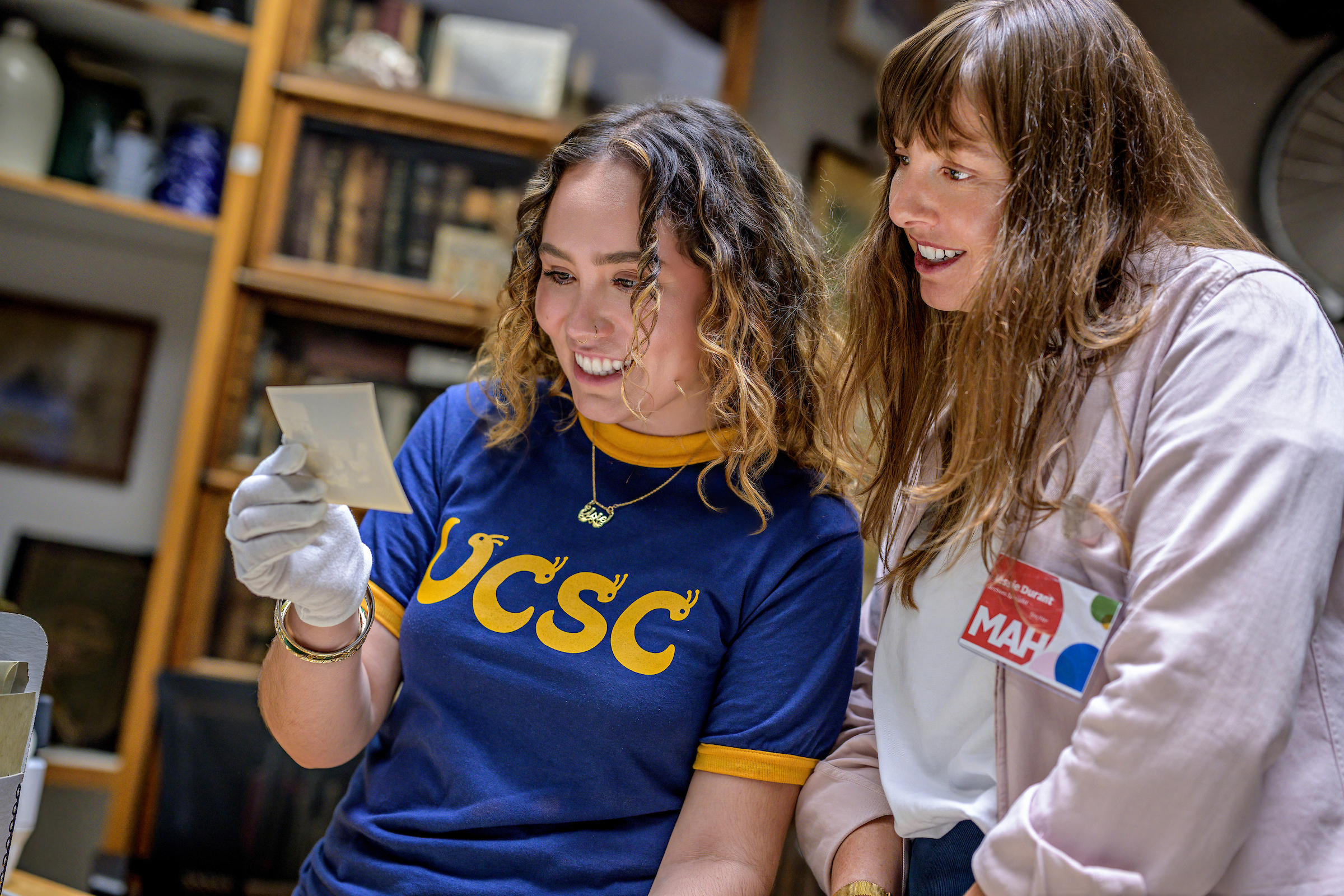 a student and a Santa Cruz MAH staff member looking at archival material together