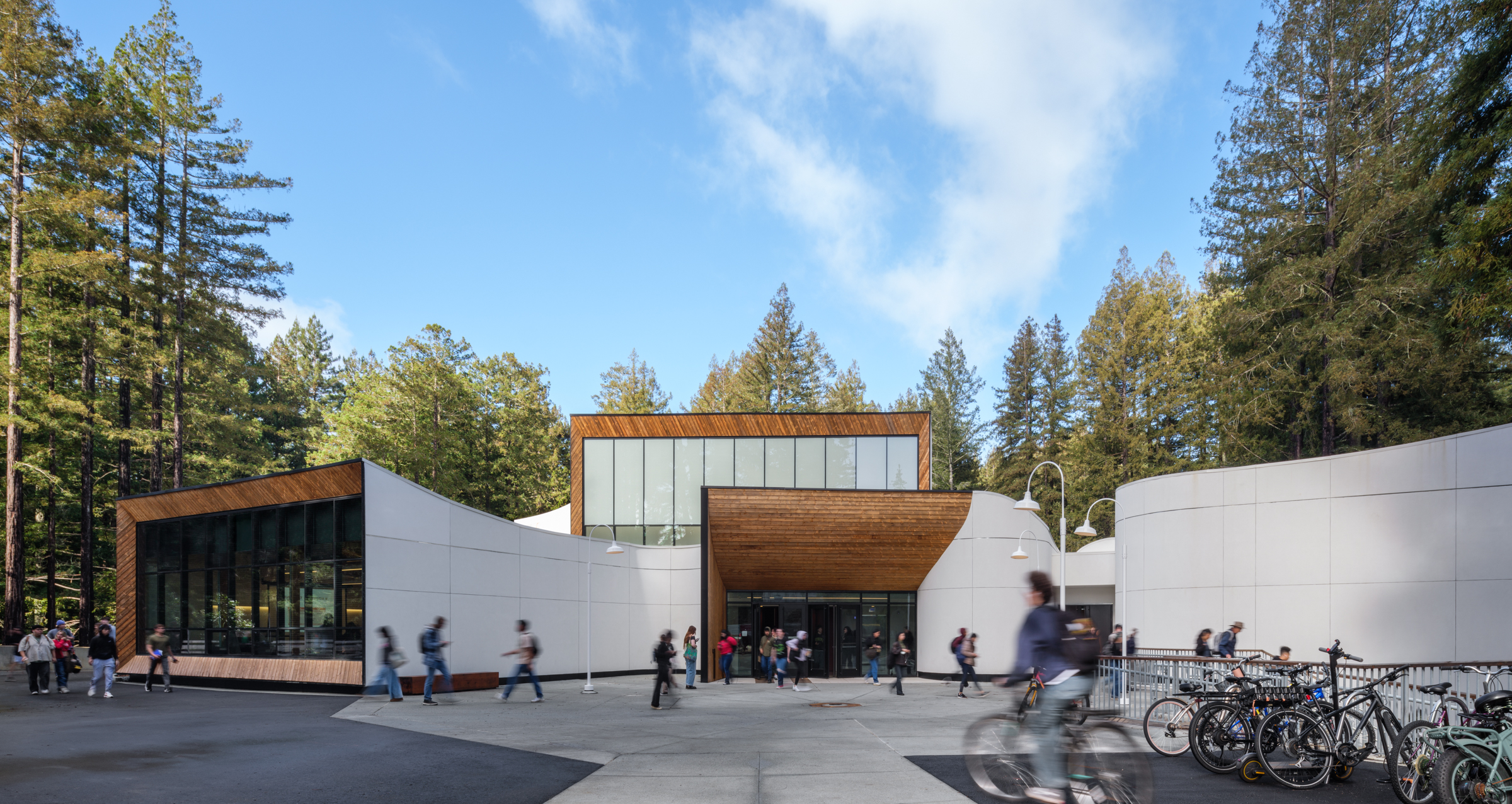 Kresge building with students walking and biking