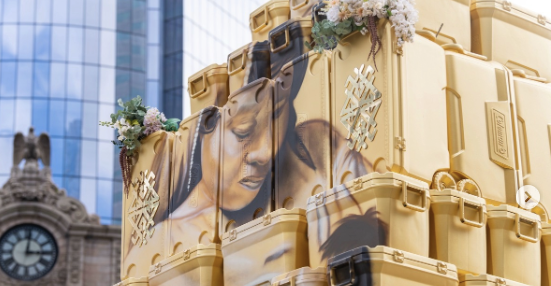 close up of face painted on pyramid of ice coolers